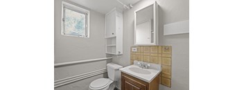 a bathroom with a toilet sink and mirror